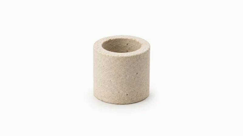 Isolated a fused ceramic Raschig ring column packing centred on a seamless pale off-white studio background, generous empty margin on every side for overlaid branding