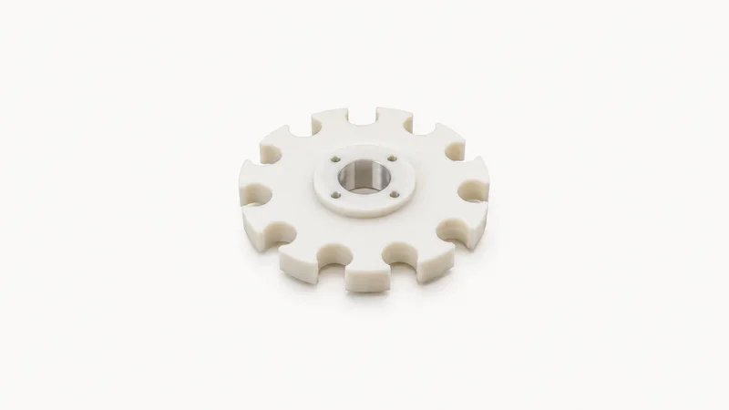 Isolated a machined delrin star wheel for bottles centred on a seamless pale off-white studio background, generous empty margin on every side for overlaid branding