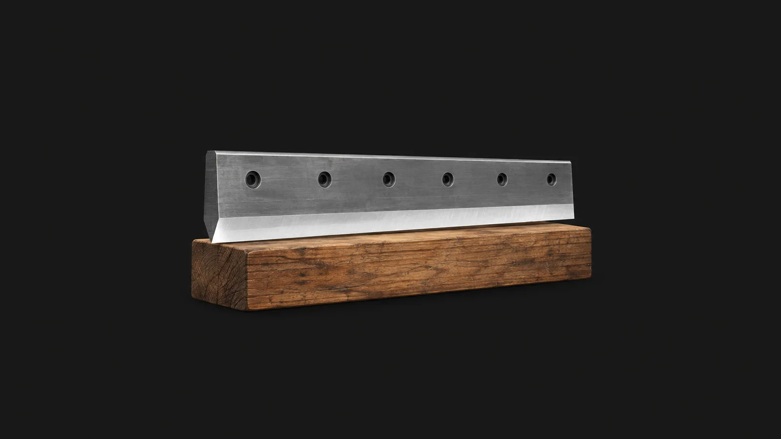 Isolated a thick steel guillotine blade with a honed bevel on a wooden block centred on a seamless deep charcoal near-black studio background, generous empty margin on every side for overlaid branding