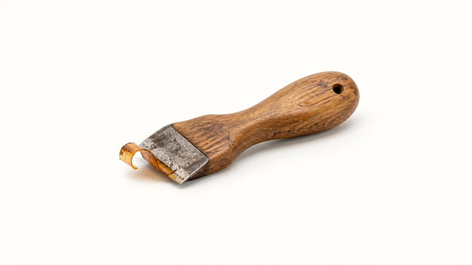 Isolated a wooden hand scraper with a curled shaving of old varnish centred on a seamless pale off-white studio background, generous empty margin on every side for overlaid branding