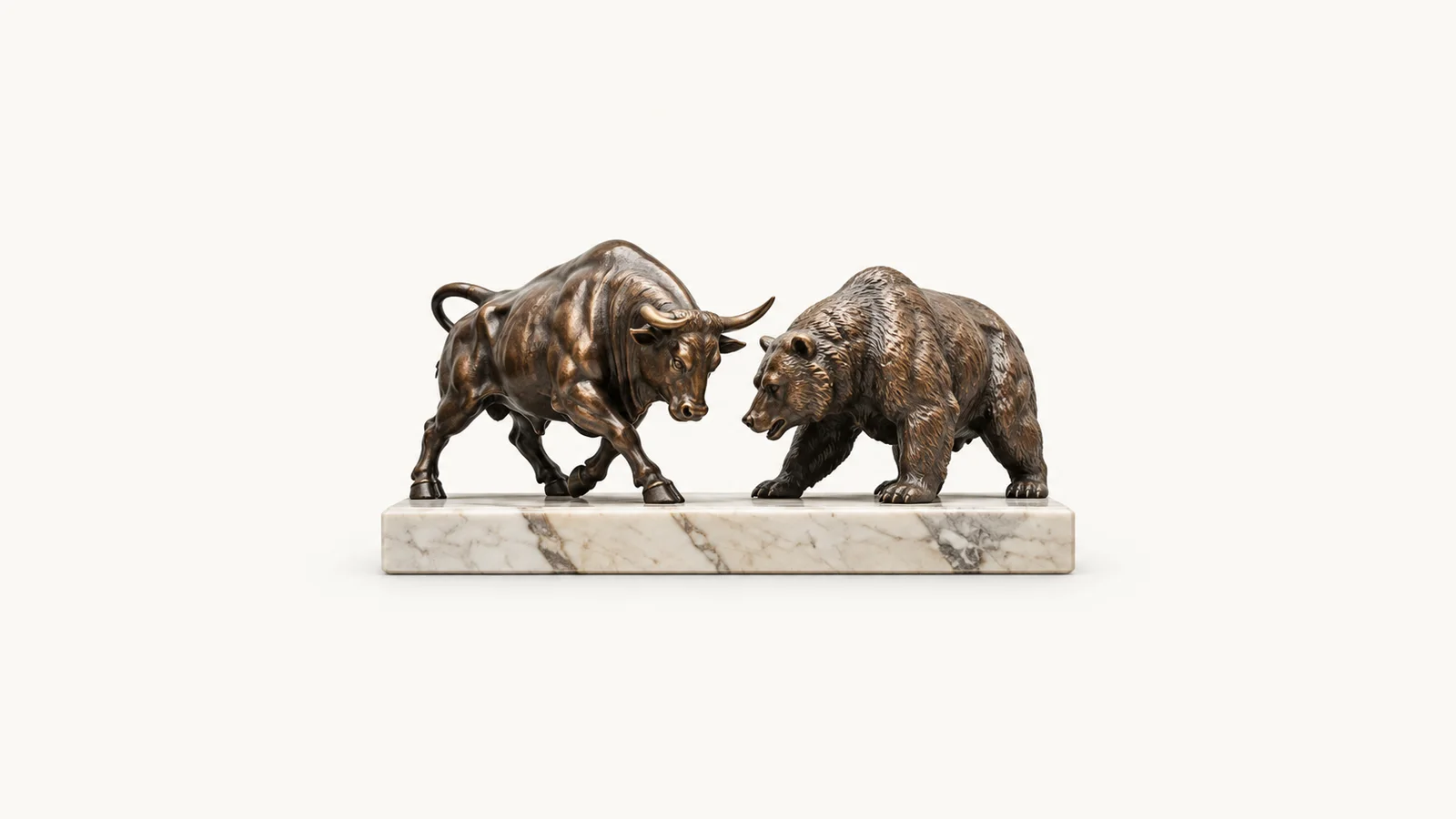 Isolated a cast-metal bull and bear pair on a marble base centred on a seamless pale off-white studio background, generous empty margin on every side for overlaid branding