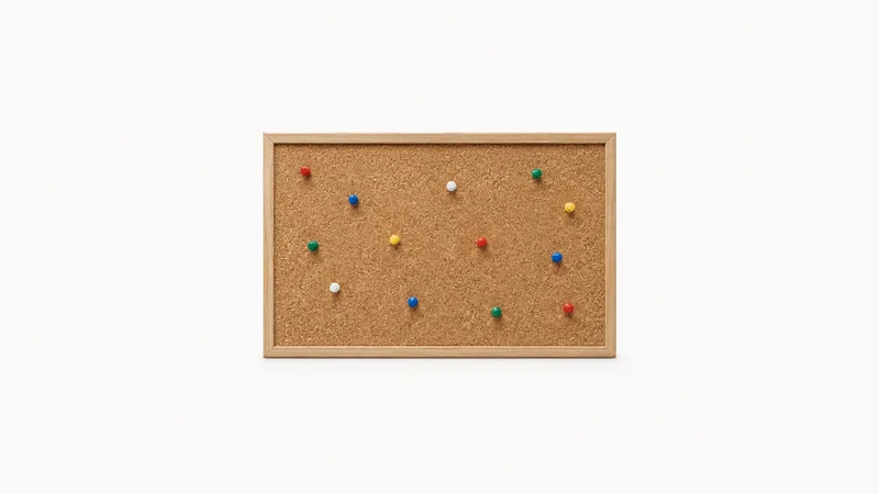 Isolated a cork pinboard with an array of coloured push pins centred on a seamless pale off-white studio background, generous empty margin on every side for overlaid branding