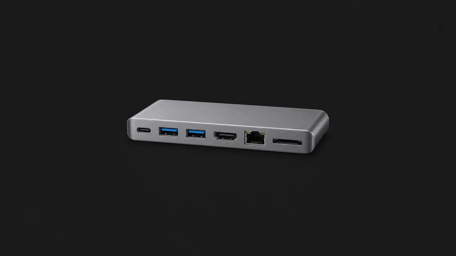 Isolated a USB hub of matte aluminium with six ports centred on a seamless deep charcoal near-black studio background, generous empty margin on every side for overlaid branding