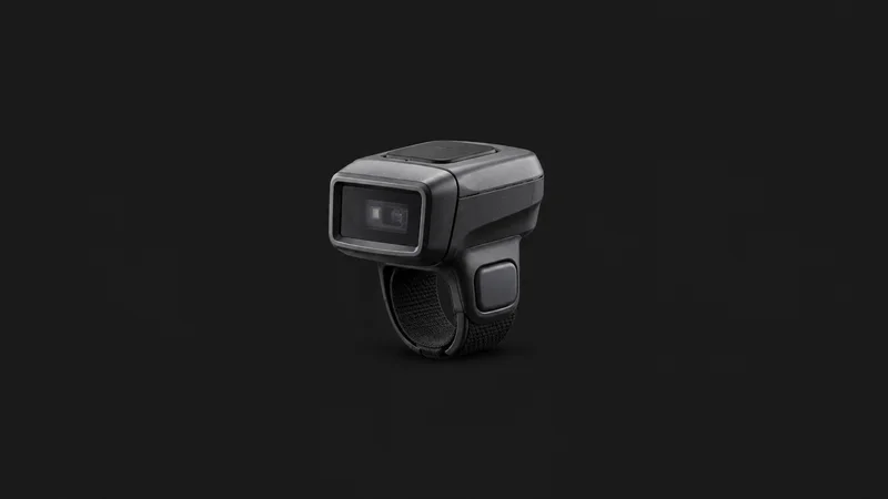 Isolated a wireless barcode ring scanner centred on a seamless deep charcoal near-black studio background, generous empty margin on every side for overlaid branding