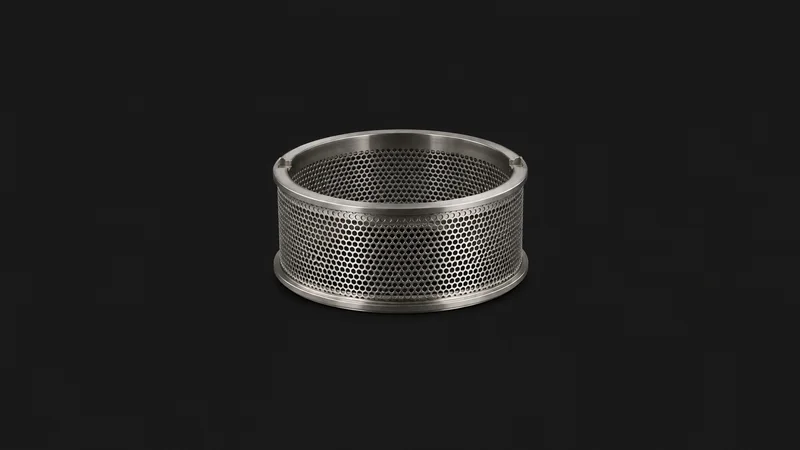Isolated a stainless sieve screen from a granulator centred on a seamless deep charcoal near-black studio background, generous empty margin on every side for overlaid branding