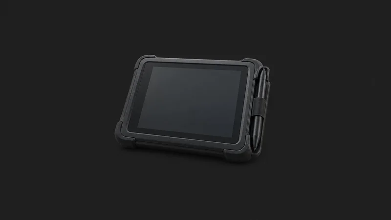 Isolated a black rubber-armoured signature-capture pad with a stylus centred on a seamless deep charcoal near-black studio background, generous empty margin on every side for overlaid branding