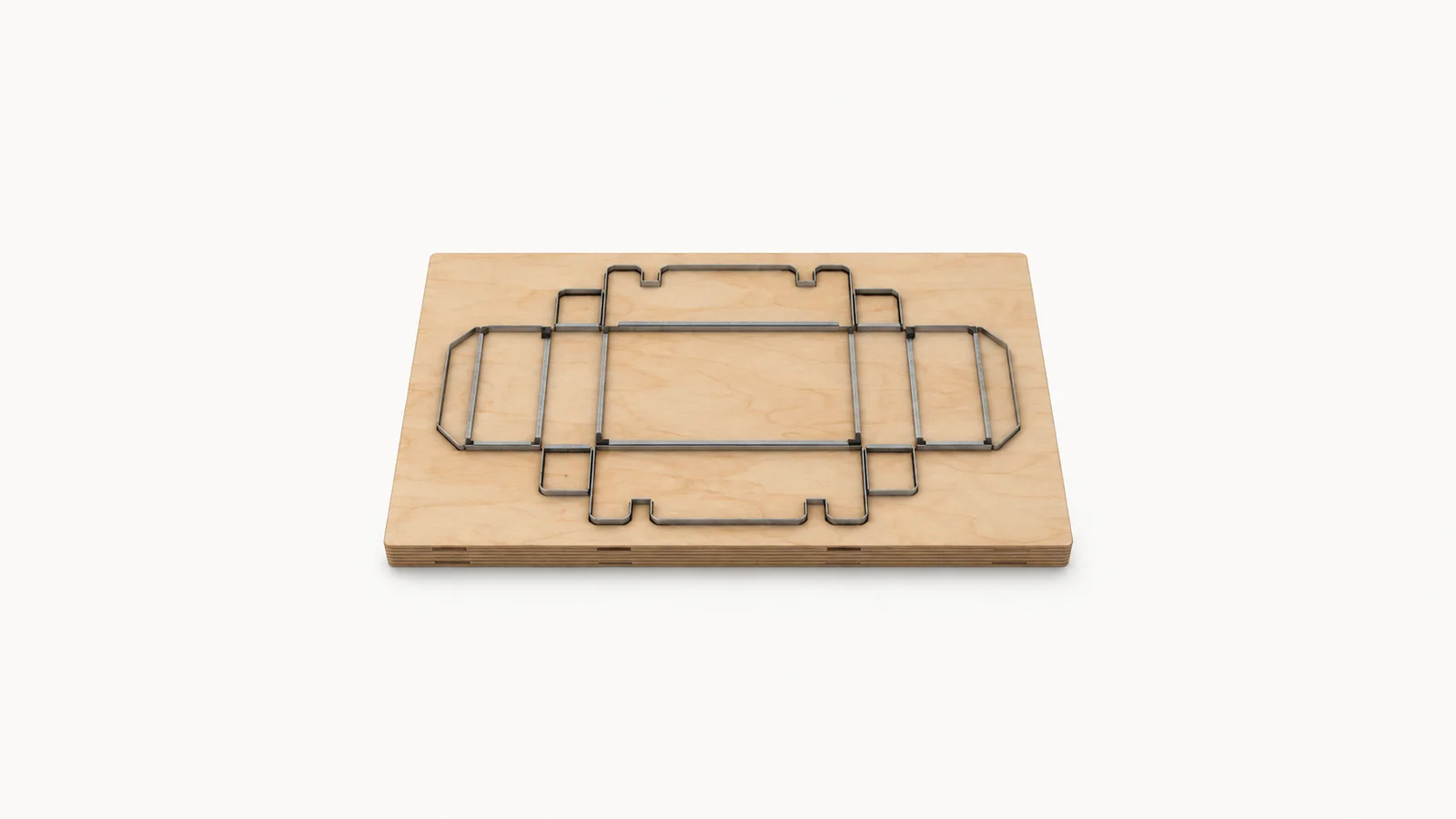 Isolated a steel-rule cutting die mounted on plywood centred on a seamless pale off-white studio background, generous empty margin on every side for overlaid branding