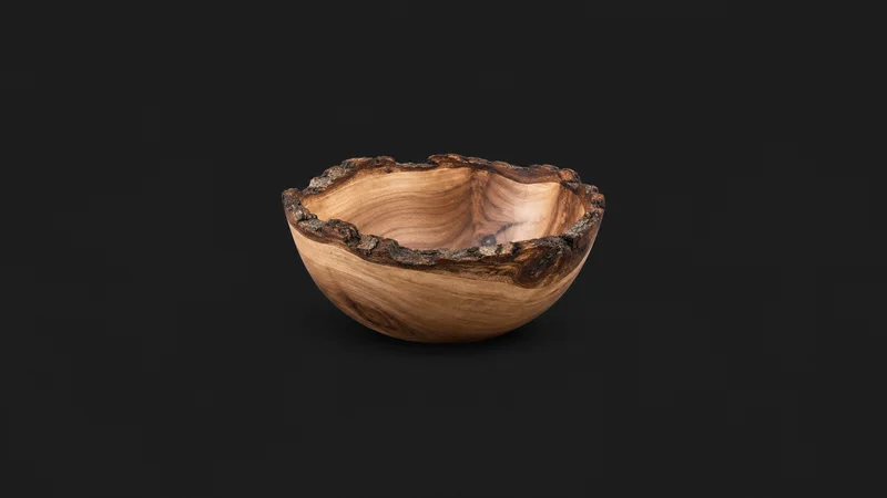 Isolated a turned wooden bowl with a bark edge centred on a seamless deep charcoal near-black studio background, generous empty margin on every side for overlaid branding