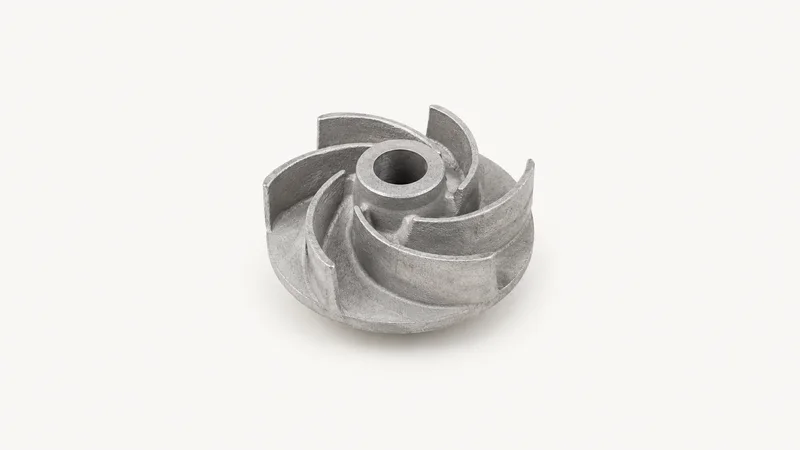 Isolated a cast aluminium impeller with unmachined surfaces centred on a seamless pale off-white studio background, generous empty margin on every side for overlaid branding