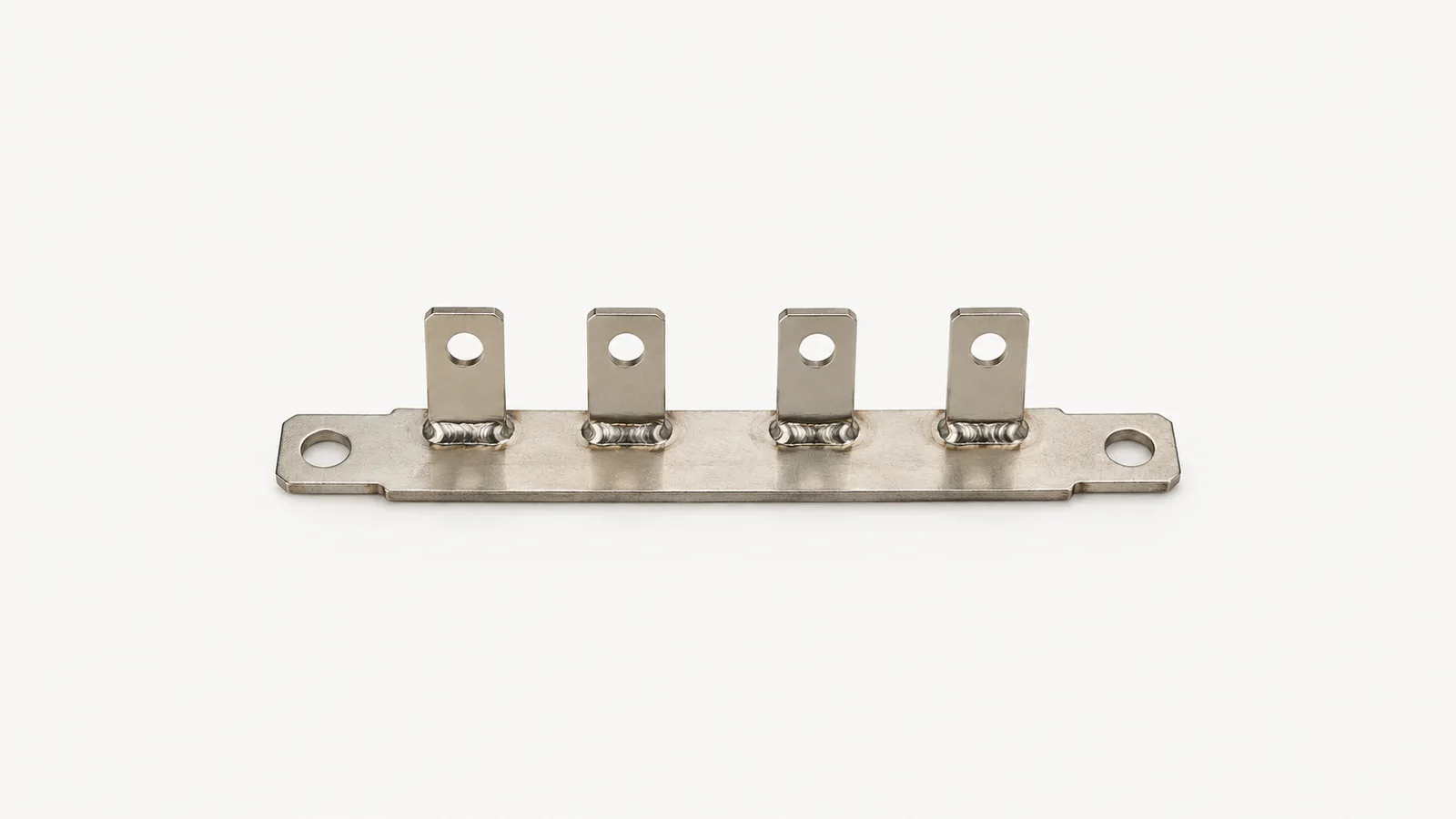 Isolated a nickel-plated busbar with welded tabs centred on a seamless pale off-white studio background, generous empty margin on every side for overlaid branding