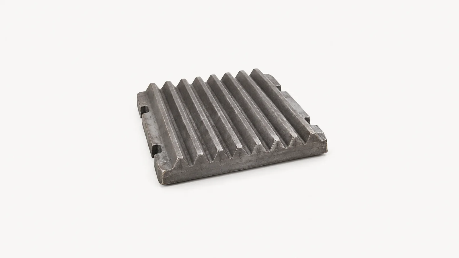 Isolated a crusher jaw plate in manganese steel centred on a seamless pale off-white studio background, generous empty margin on every side for overlaid branding