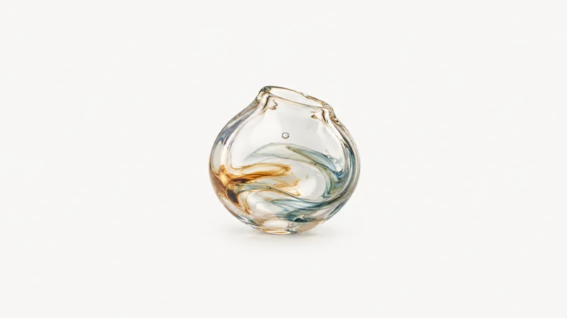 Isolated a half-formed glass bubble with a swirl of trapped colour centred on a seamless pale off-white studio background, generous empty margin on every side for overlaid branding