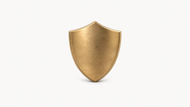 Isolated a brass paperweight shaped as a shield centred on a seamless pale off-white studio background, generous empty margin on every side for overlaid branding