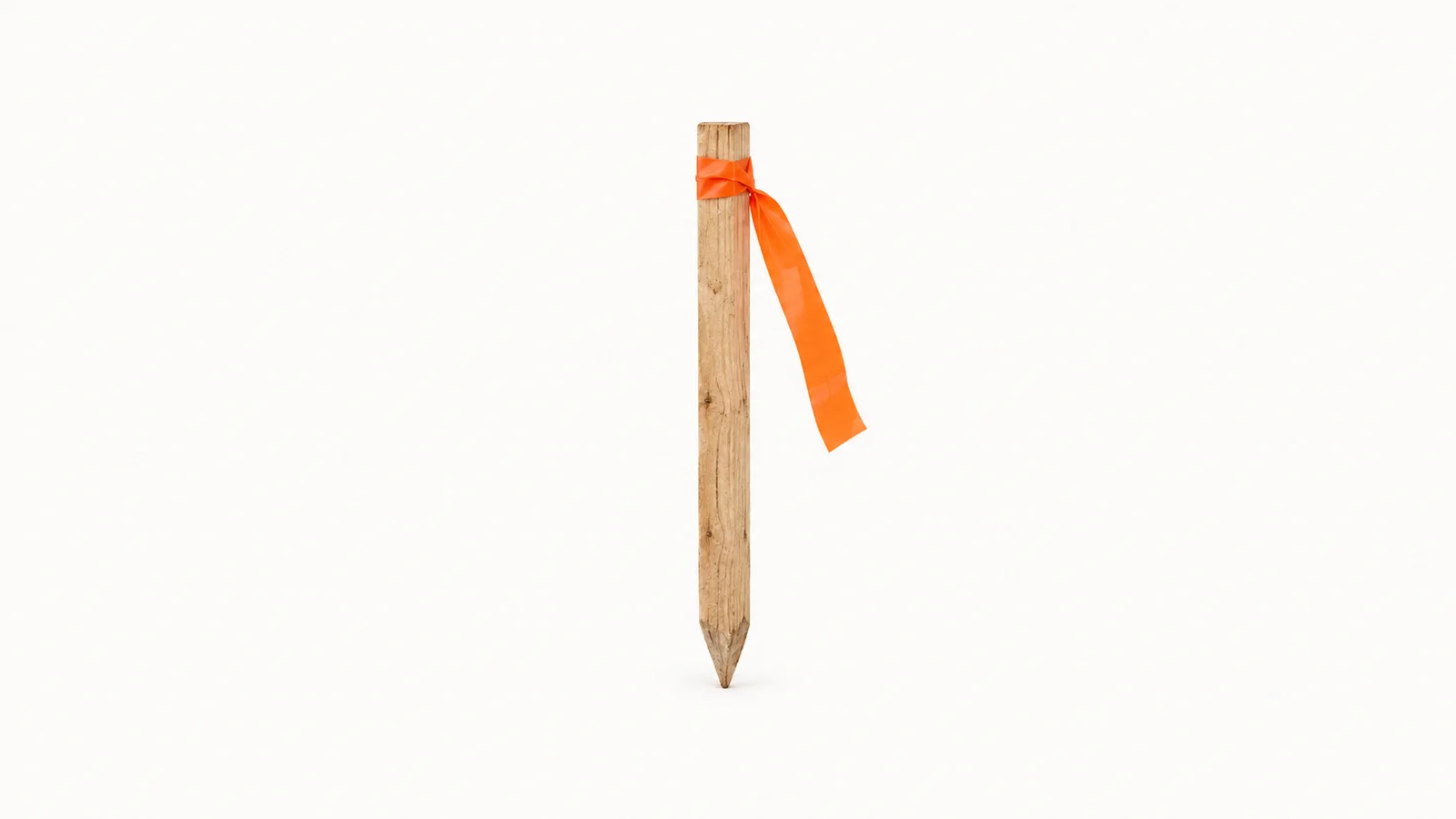 Isolated a wooden survey peg with a ribbon of orange flagging tape centred on a seamless pale off-white studio background, generous empty margin on every side for overlaid branding