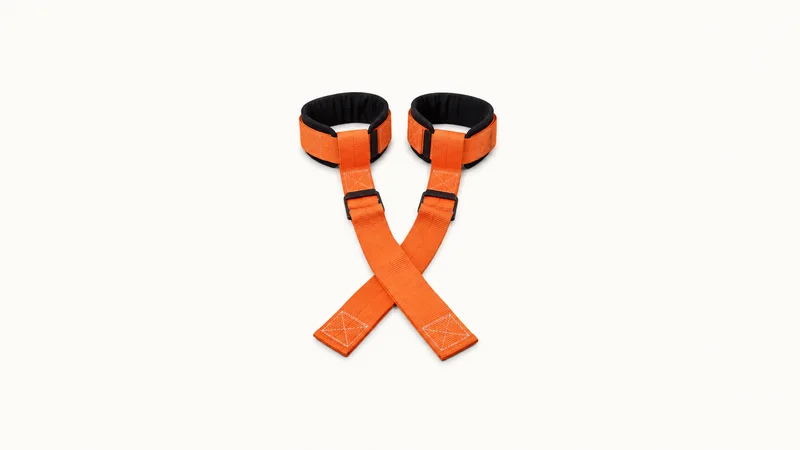 Isolated a piano-mover's forearm lifting straps laid out flat centred on a seamless pale off-white studio background, generous empty margin on every side for overlaid branding