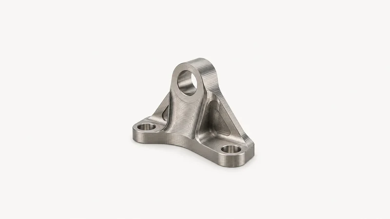 Isolated a titanium bracket with visible ball-mill scallop tool paths centred on a seamless pale off-white studio background, generous empty margin on every side for overlaid branding