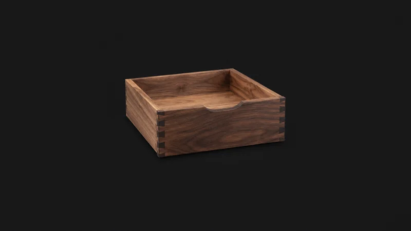 Isolated a cabinet drawer with hand-cut joints centred on a seamless deep charcoal near-black studio background, generous empty margin on every side for overlaid branding