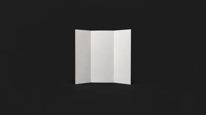 Isolated a blank folded tri-fold brochure standing on its edge centred on a seamless deep charcoal near-black studio background, generous empty margin on every side for overlaid branding