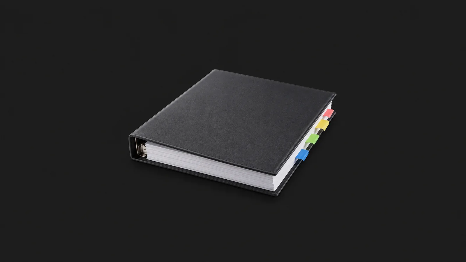 Isolated a blank signature-tabbed closing binder with coloured flags centred on a seamless deep charcoal near-black studio background, generous empty margin on every side for overlaid branding
