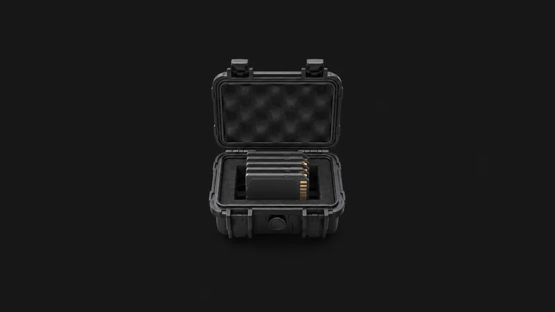 Isolated a stack of professional memory cards in a rugged case centred on a seamless deep charcoal near-black studio background, generous empty margin on every side for overlaid branding