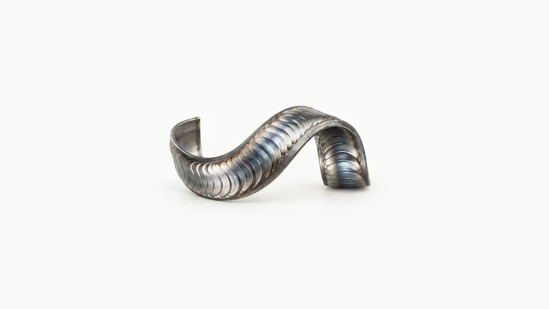 Abstract a stacked-dime weld bead ribbon in stainless steel motif centred on a seamless pale off-white studio background, generous empty margin for overlaid branding