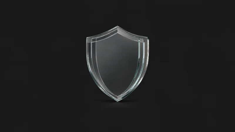 Abstract a shield silhouette built from layered glass plates motif centred on a seamless deep charcoal near-black studio background, generous empty margin for overlaid branding