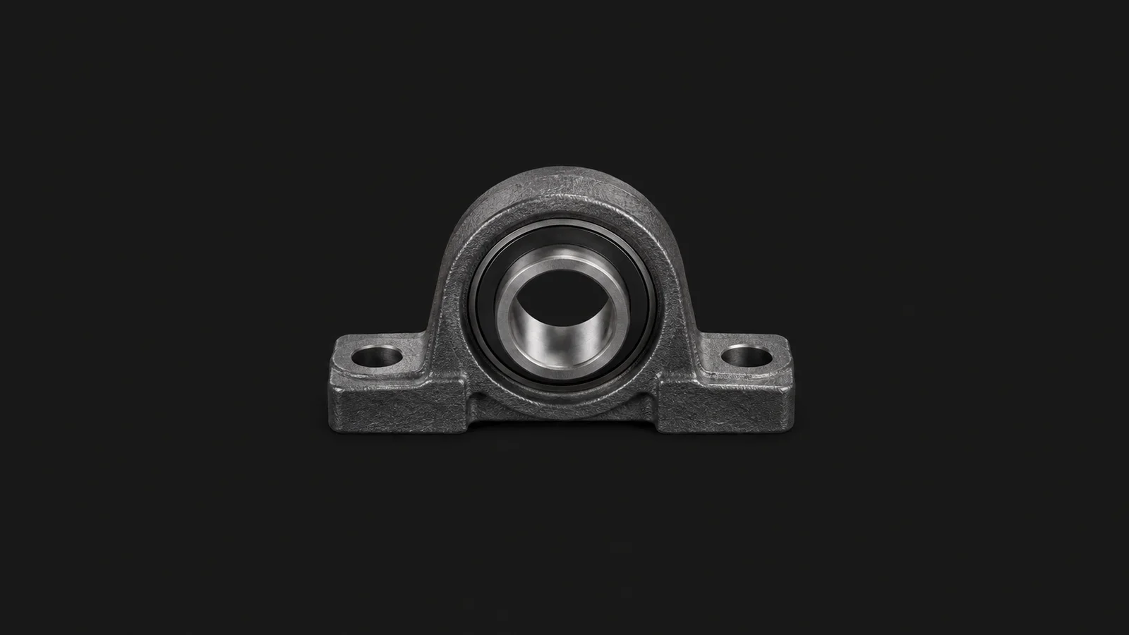 Isolated a pillow-block bearing housing in cast iron centred on a seamless deep charcoal near-black studio background, generous empty margin on every side for overlaid branding