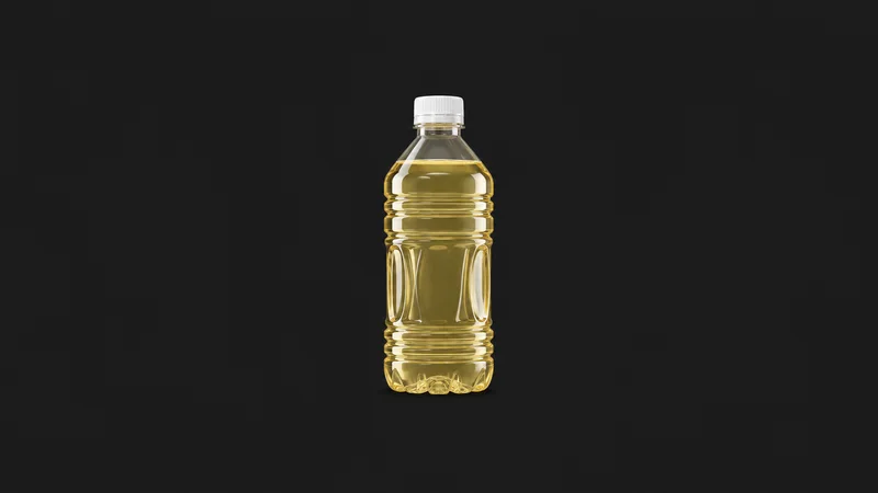 Isolated a capped clear plastic bottle of filled product without a label centred on a seamless deep charcoal near-black studio background, generous empty margin on every side for overlaid branding