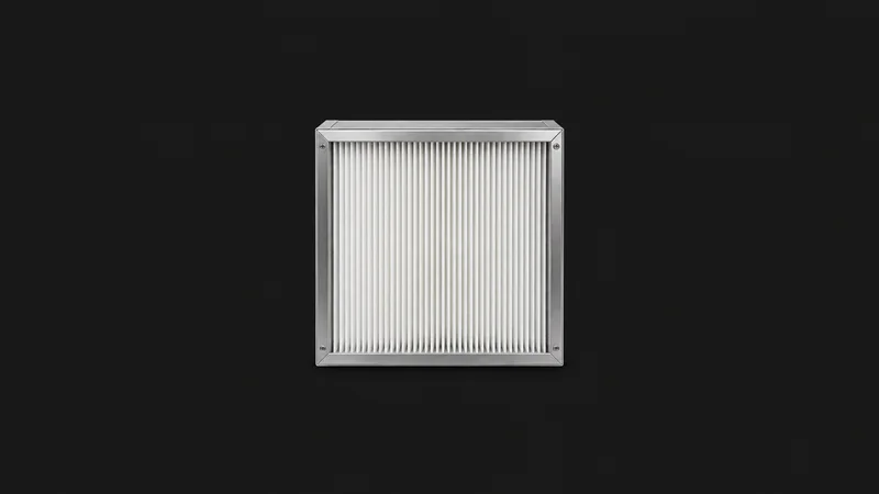 Isolated a HEPA filter cartridge in a stainless frame centred on a seamless deep charcoal near-black studio background, generous empty margin on every side for overlaid branding
