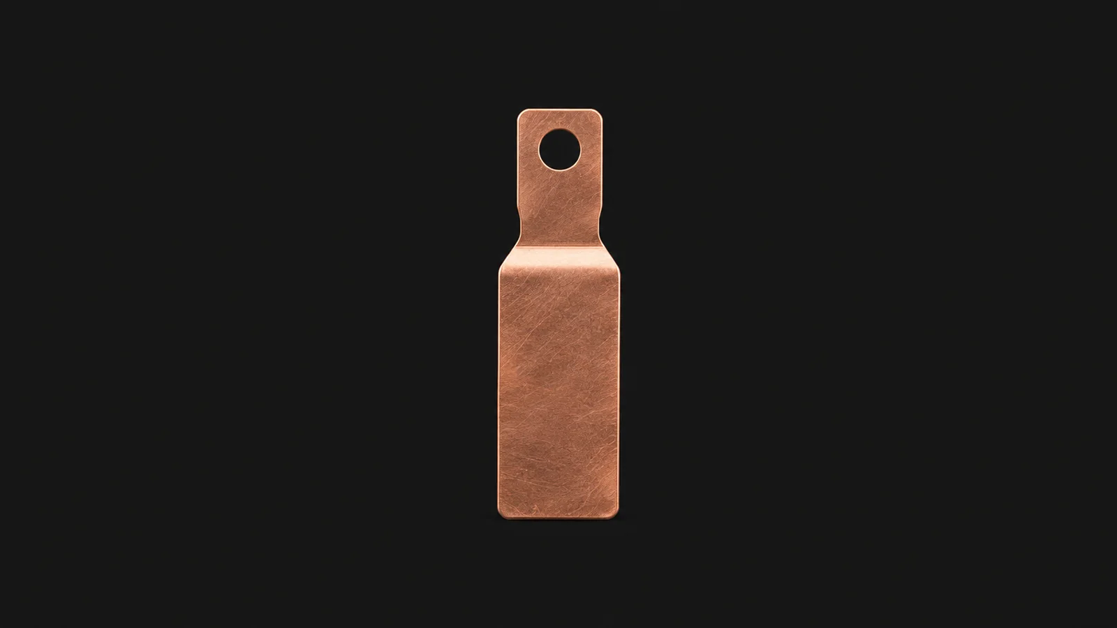 Isolated a battery-cell current collector tab in bare copper centred on a seamless deep charcoal near-black studio background, generous empty margin on every side for overlaid branding