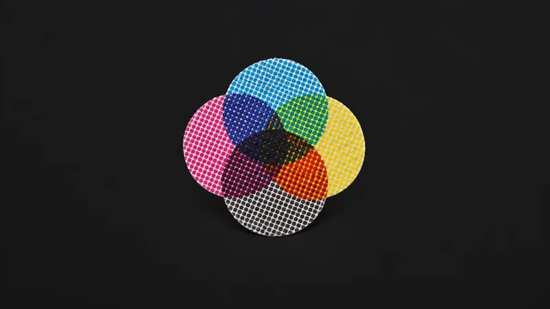 Abstract overlapping CMYK halftone rosettes magnified motif centred on a seamless deep charcoal near-black studio background, generous empty margin for overlaid branding