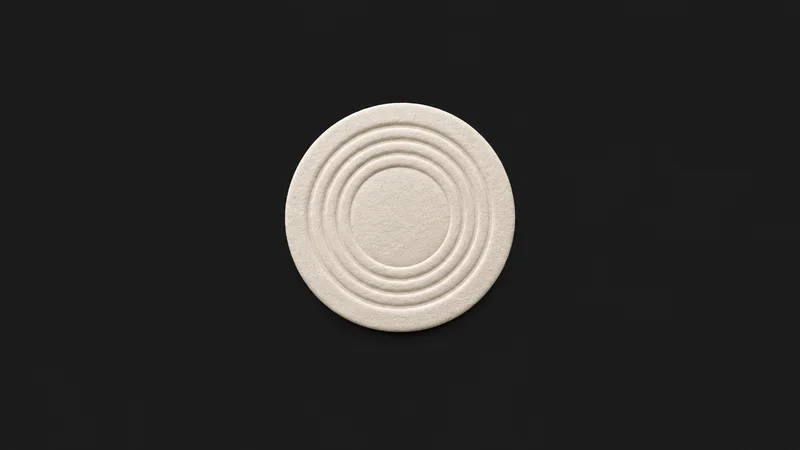 Abstract a ring of concentric ridges pressed into cream card stock motif centred on a seamless deep charcoal near-black studio background, generous empty margin for overlaid branding