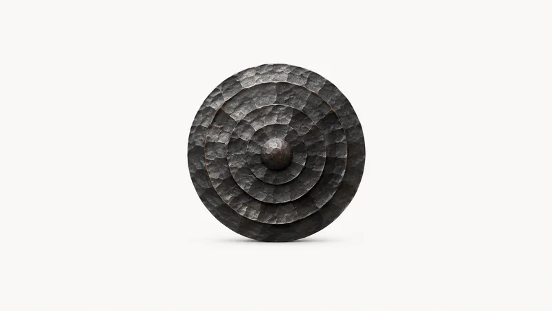 Abstract a scale-textured hammered iron surface with concentric facets motif centred on a seamless pale off-white studio background, generous empty margin for overlaid branding