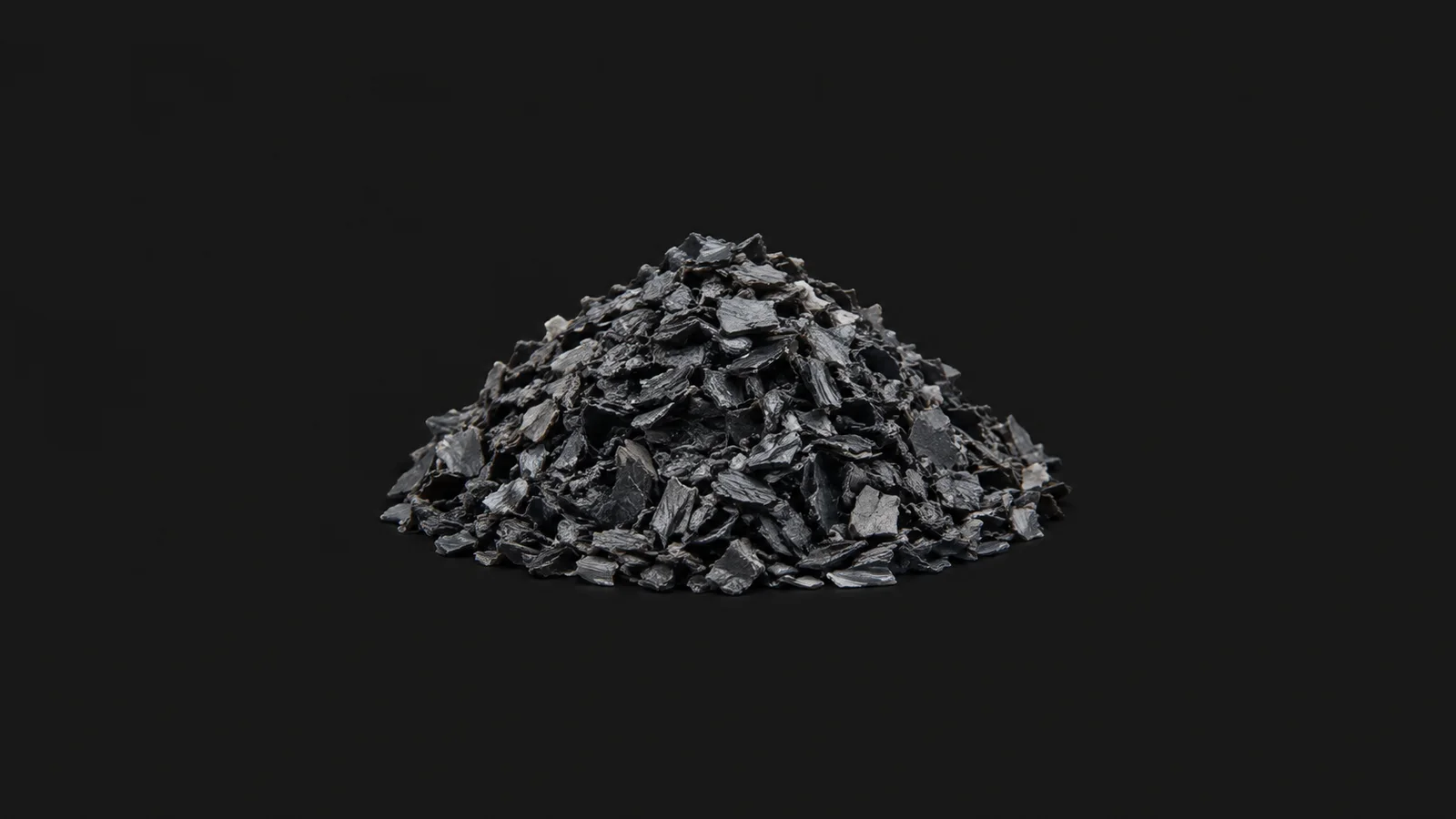 Abstract a dense mound of sorted plastic flakes in one colour motif centred on a seamless deep charcoal near-black studio background, generous empty margin for overlaid branding