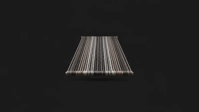 Abstract a taut array of parallel warp threads in perspective motif centred on a seamless deep charcoal near-black studio background, generous empty margin for overlaid branding