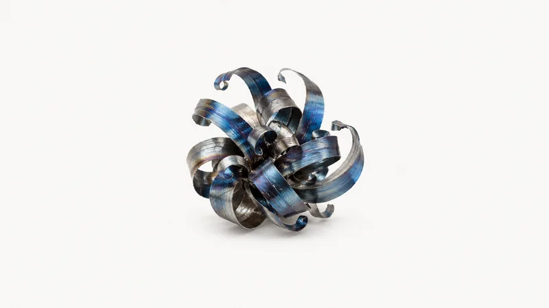 Abstract a bloom of blue-tempered steel swarf curling upward motif centred on a seamless pale off-white studio background, generous empty margin for overlaid branding