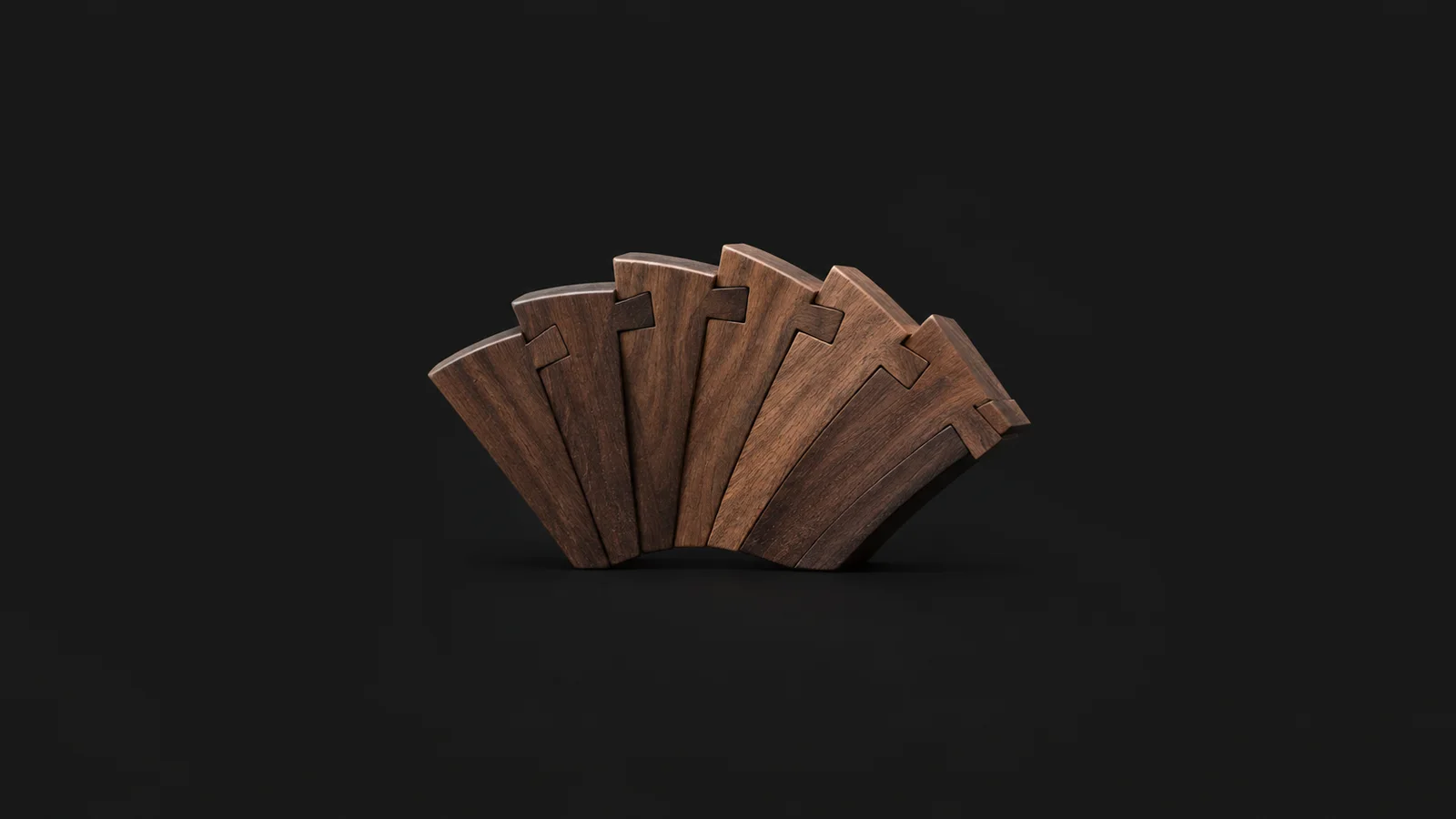 Abstract a fan of dovetail-joint silhouettes interlocking in a curve motif centred on a seamless deep charcoal near-black studio background, generous empty margin for overlaid branding