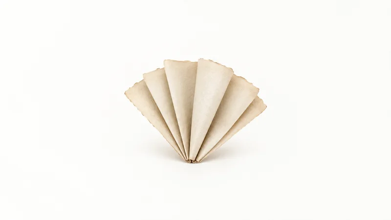 Abstract a stack of parchment sheets fanned like a folded fan motif centred on a seamless pale off-white studio background, generous empty margin for overlaid branding