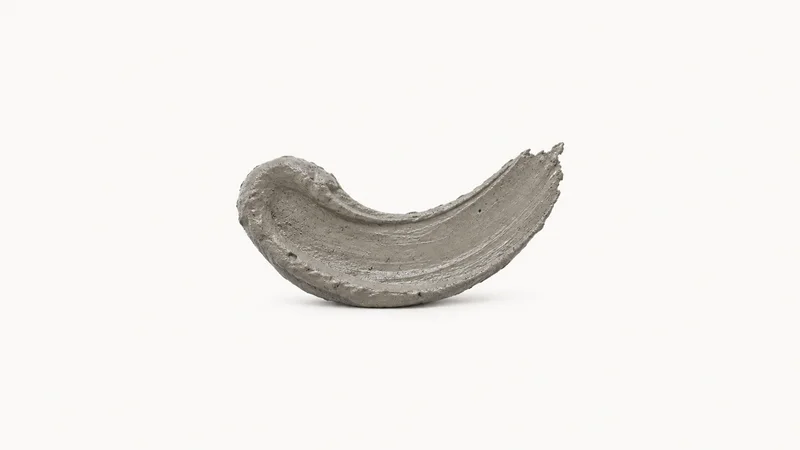 Abstract a pour of wet concrete swirled into a smooth grey curve motif centred on a seamless pale off-white studio background, generous empty margin for overlaid branding