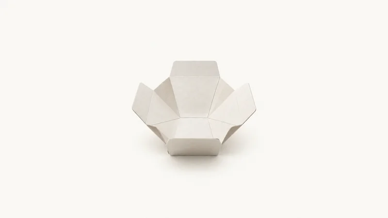 Abstract a lattice of scored crease lines radiating across board motif centred on a seamless pale off-white studio background, generous empty margin for overlaid branding