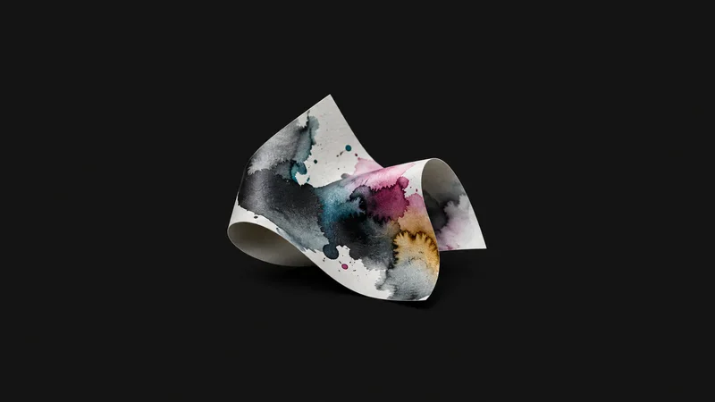 Abstract a spread of ink droplets blooming on coated stock motif centred on a seamless deep charcoal near-black studio background, generous empty margin for overlaid branding
