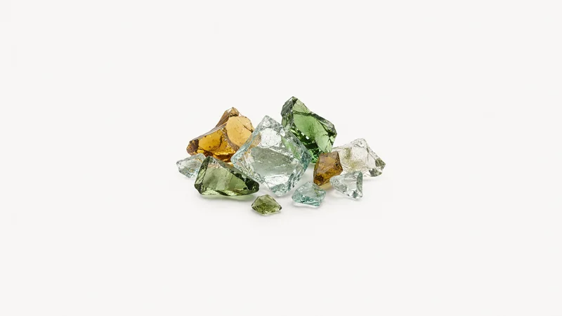 Abstract a scatter of glass cullet fragments catching the light motif centred on a seamless pale off-white studio background, generous empty margin for overlaid branding
