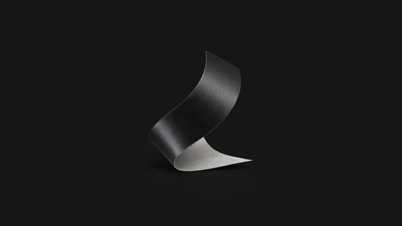Abstract a ribbon of cut vinyl peeling from its liner motif centred on a seamless deep charcoal near-black studio background, generous empty margin for overlaid branding