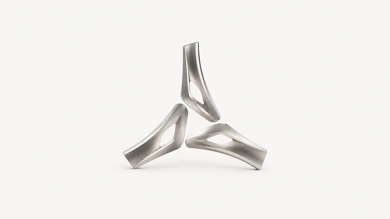 Abstract a spoke pattern of alloy wheel arcs in brushed aluminium motif centred on a seamless pale off-white studio background, generous empty margin for overlaid branding