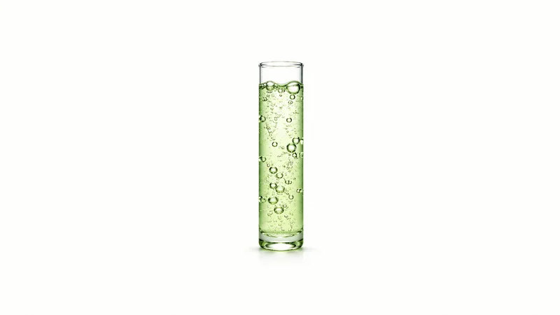 Abstract rising bubbles suspended in a column of pale green liquid motif centred on a seamless pale off-white studio background, generous empty margin for overlaid branding