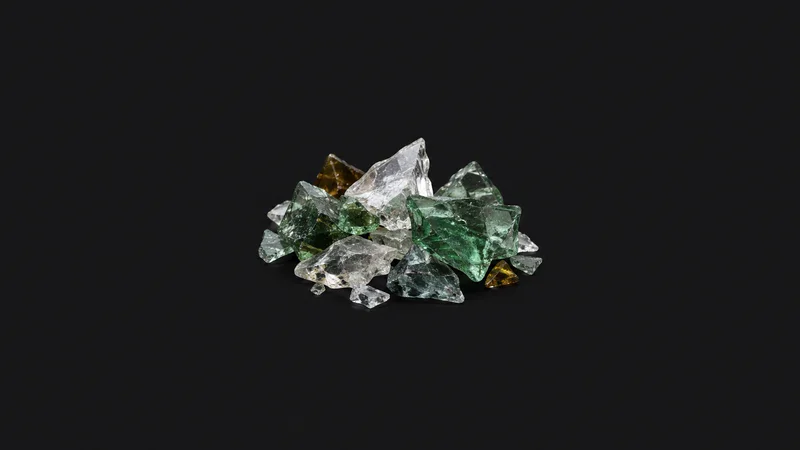 Abstract a scatter of glass cullet fragments catching the light motif centred on a seamless deep charcoal near-black studio background, generous empty margin for overlaid branding