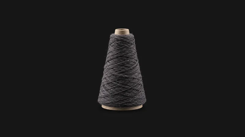 Abstract a spiralling wrap of yarn around a conical core motif centred on a seamless deep charcoal near-black studio background, generous empty margin for overlaid branding