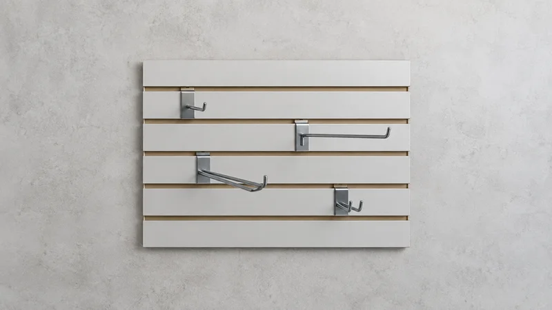 Styled flat-lay of a slatwall display panel with hooks on a clean background, clean even studio light, generous negative space for overlaid text