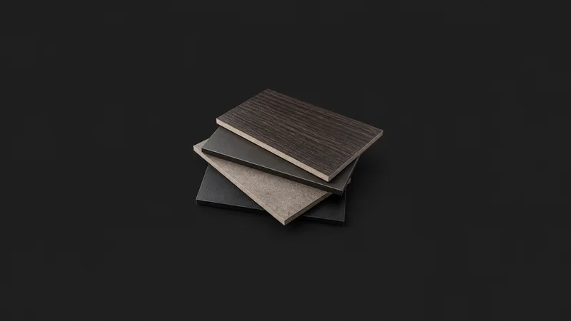 Abstract a stack of laminate finish samples motif centred on a seamless deep charcoal near-black studio background, generous empty margin for overlaid branding