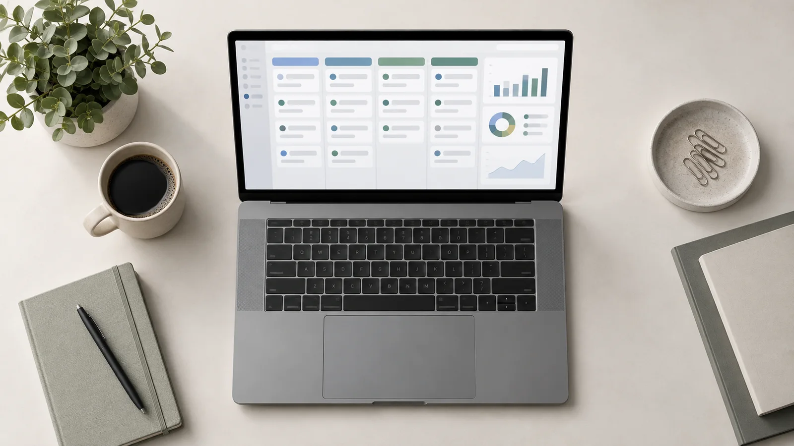 Styled flat-lay of a laptop displaying an abstract, unreadable CRM pipeline dashboard on a clean background, soft studio light, generous negative space for overlaid text